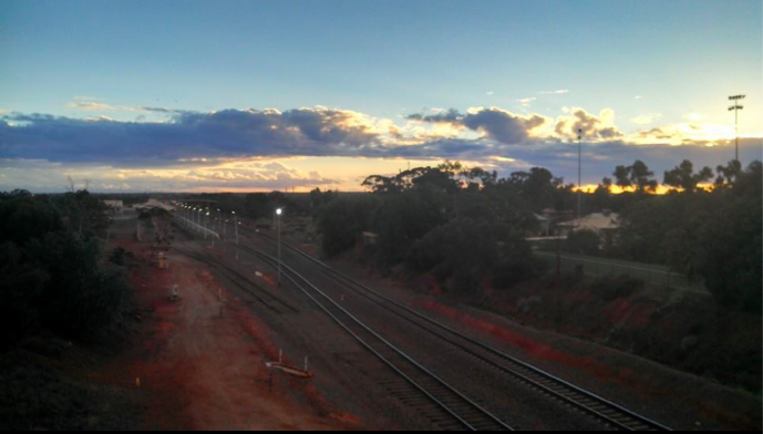 The train tracks with the storm moving in