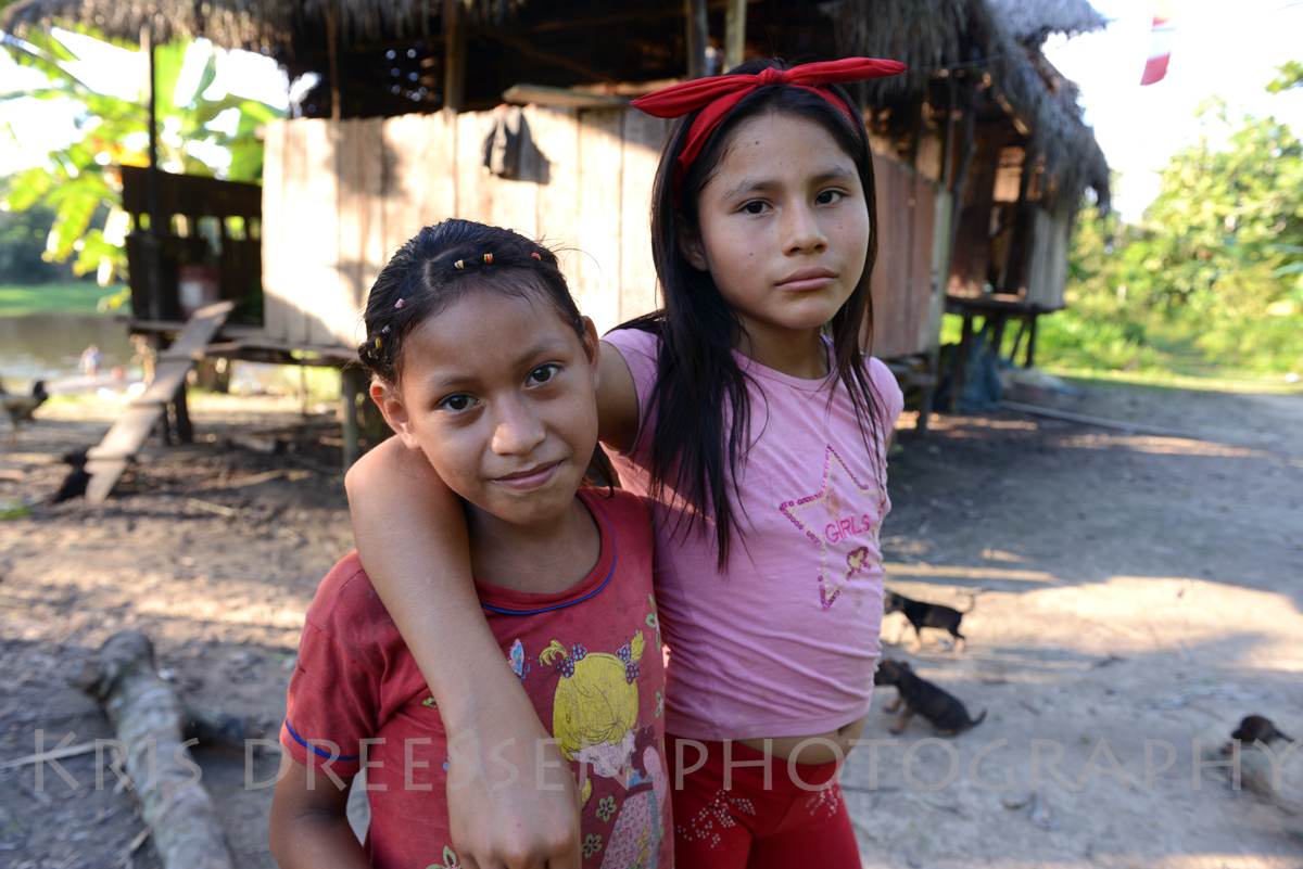 Cocama girls with our guide's house in back