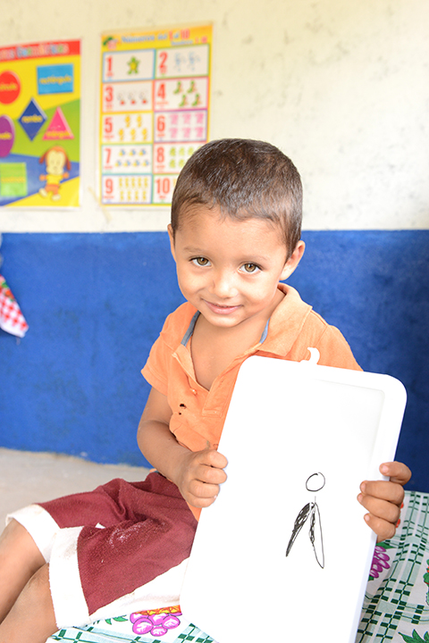 Jaunito holding The Friends Project logo